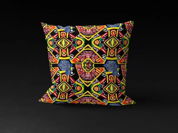 Front view of Ashanti Dreamweaver pillow cover against a black background, featuring kaleidoscopic patterns in yellow, green, black, and red with an enigmatic animal-like figure at the center.