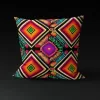 Kandake's Gem pillow cover featuring a radiant blend of orange, red, green, blue, and black patterns forming intricate diamonds.