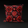 Omenala Rosette pillow cover featuring pyramid roses in black and white highlights on a red background.