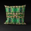 Front view of Yoruba Elegance pillow cover featuring intricate goldish-yellow and black accents on a green background.